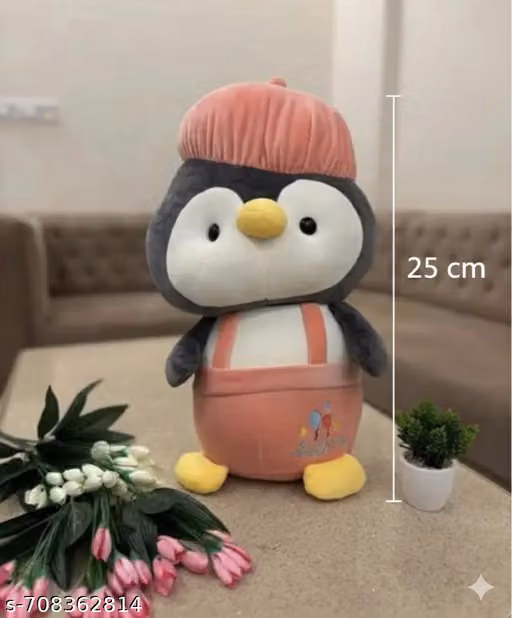 Bring home this charming penguin soft toy! Standing at 25 cm tall, this high-quality plush features a soft grey and white body, a cozy pink hat, and adorable overalls. It's the perfect size for nursery decor or a thoughtful birthday surprise.