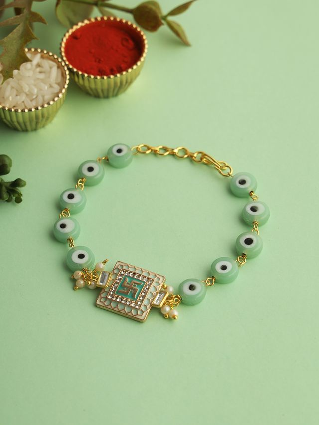 Gold Swastik Green Enameled Black Eye Bracelet Rakhi (Rakhi is included with Roli Chawal & Greetings Card)