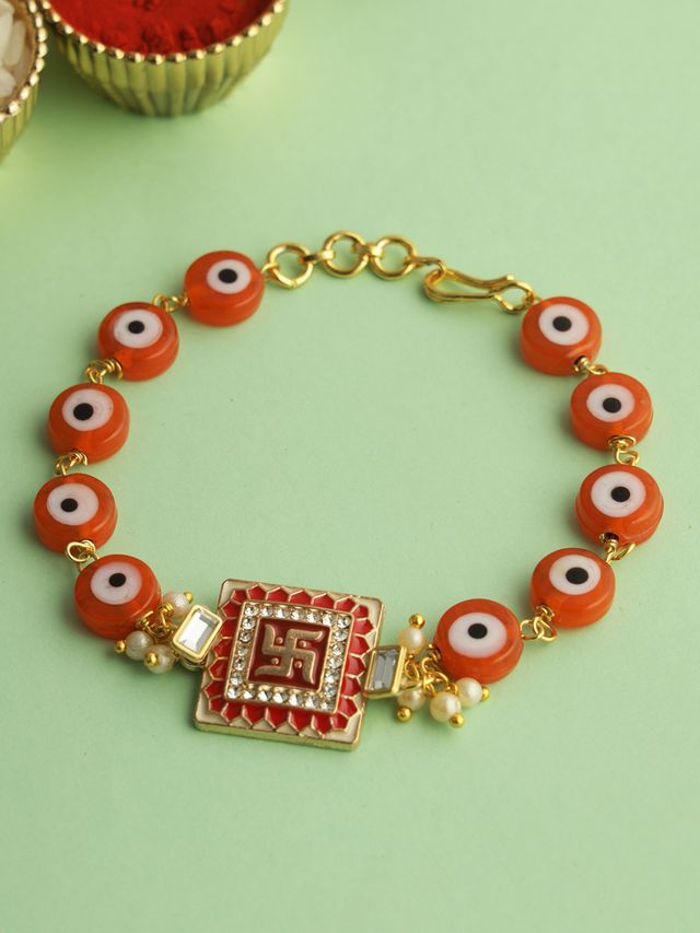 Gold Swastik Red Enameled Black Eye Bracelet Rakhi (Rakhi is included with Roli Chawal & Greetings Card)