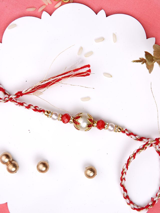 White & Red Twisted Rakhi with a Pearl (Rakhi is included with Roli Chawal & Greetings Card)