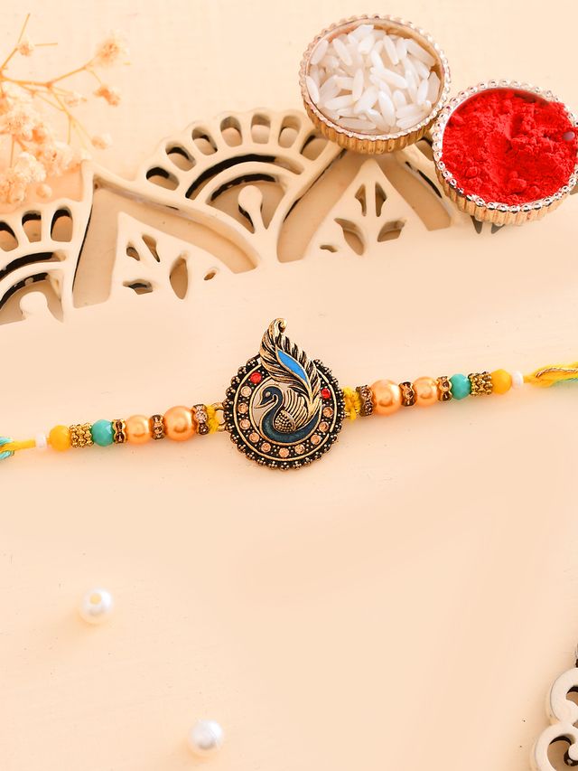 Peacock Feather Charm Rakhi (Rakhi is included with Roli Chawal & Greetings Card)