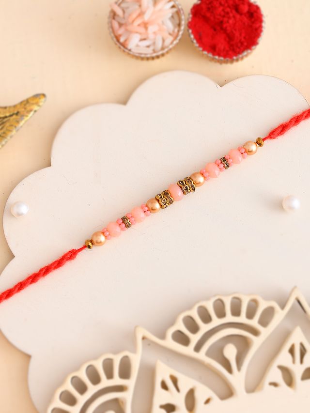 Gold & Pink Beaded Twisted Single Rakhi (Rakhi is included with Roli Chawal & Greetings Card)