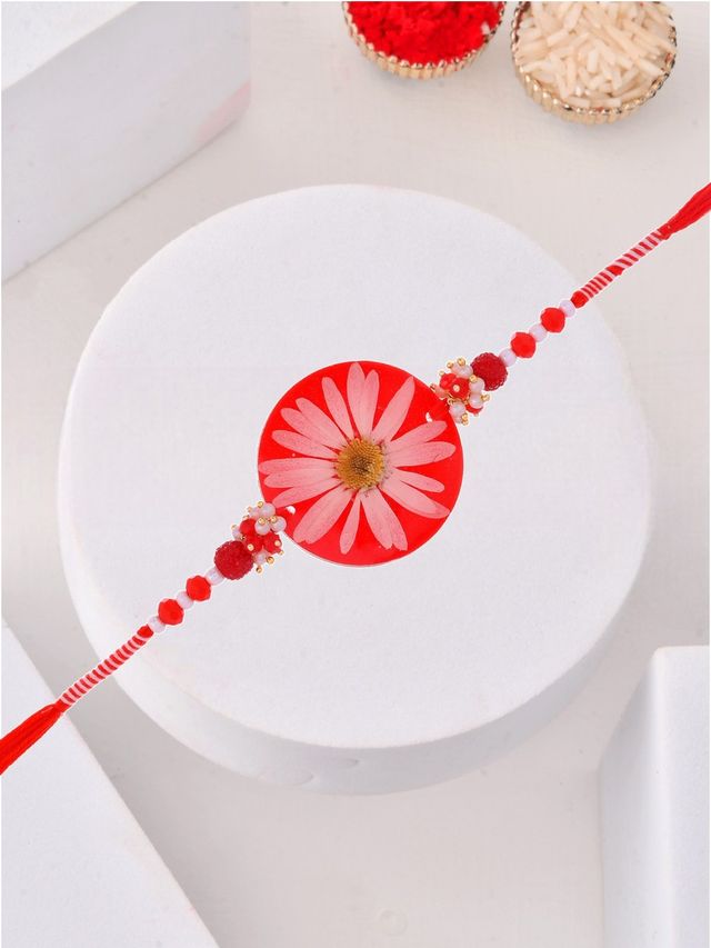 Pressed Real Flower Rakhi in Red Resin (Rakhi is included with Roli Chawal & Greetings Card)
