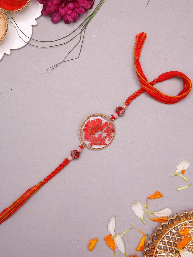 Artisanal Floral Resin Rakhi With Handcrafted Orange Thread And Rustic Beads (Rakhi is included with Roli Chawal & Greetings Card)