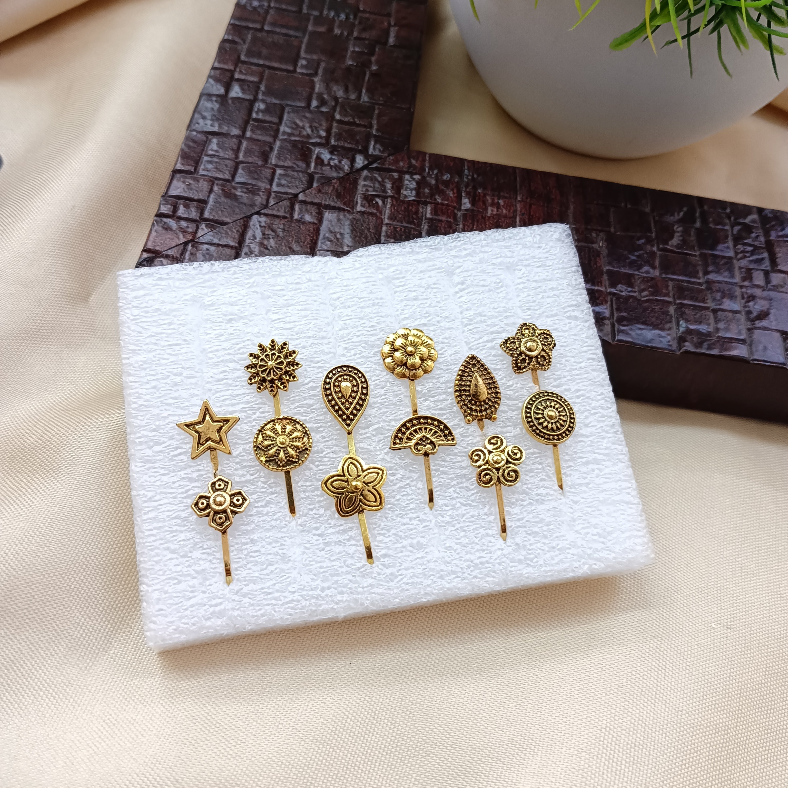 the99jewel-set-of-12-assorted-design-gold-plated-nose-pin-combo